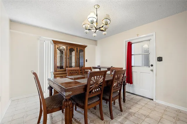 a view of a dining room with furniture and chandelier