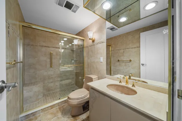 a bathroom with a sink toilet and shower