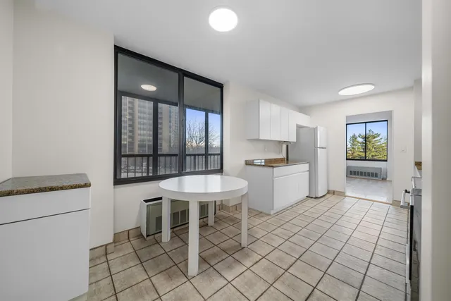a kitchen with a sink cabinets and window