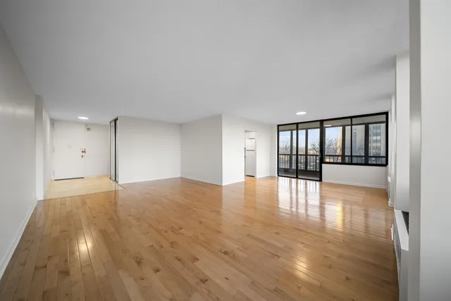 a view of an empty room and wooden floor