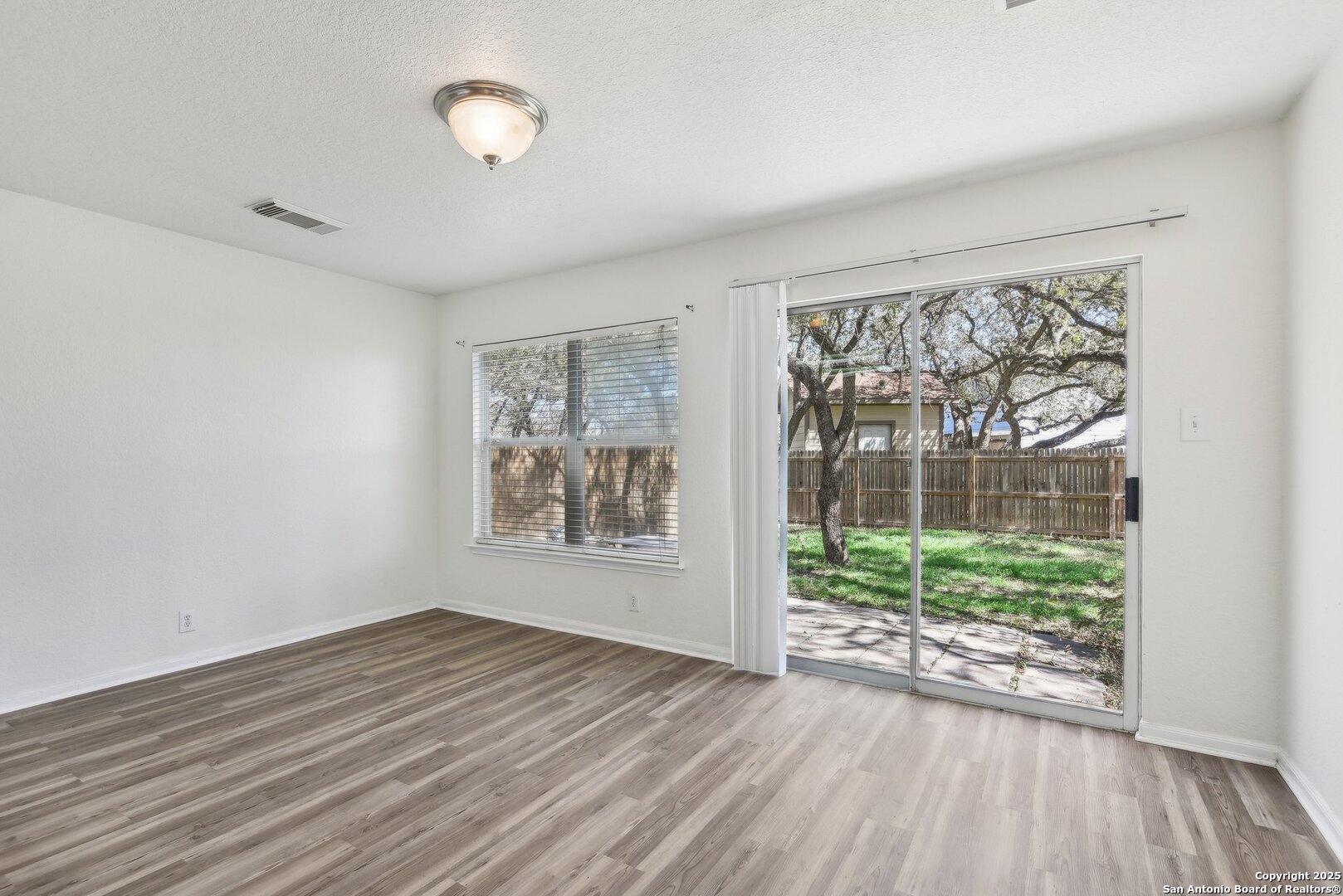 16216 Ike Lane Selma, TX 78154 - Photo 13 of 40 wooden floor in an empty room with a window