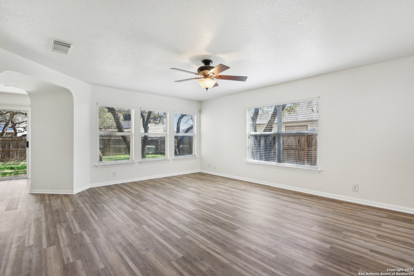 16216 Ike Lane Selma, TX 78154 - Photo 2 of 40 a view of an empty room with a window and wooden floor