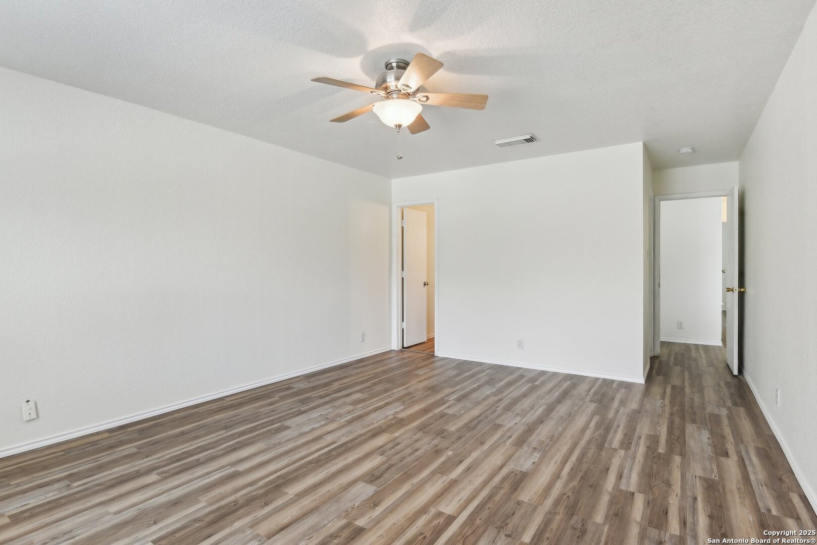 16216 Ike Lane Selma, TX 78154 - Photo 21 of 40 a view of a room with wooden floor and ceiling fan