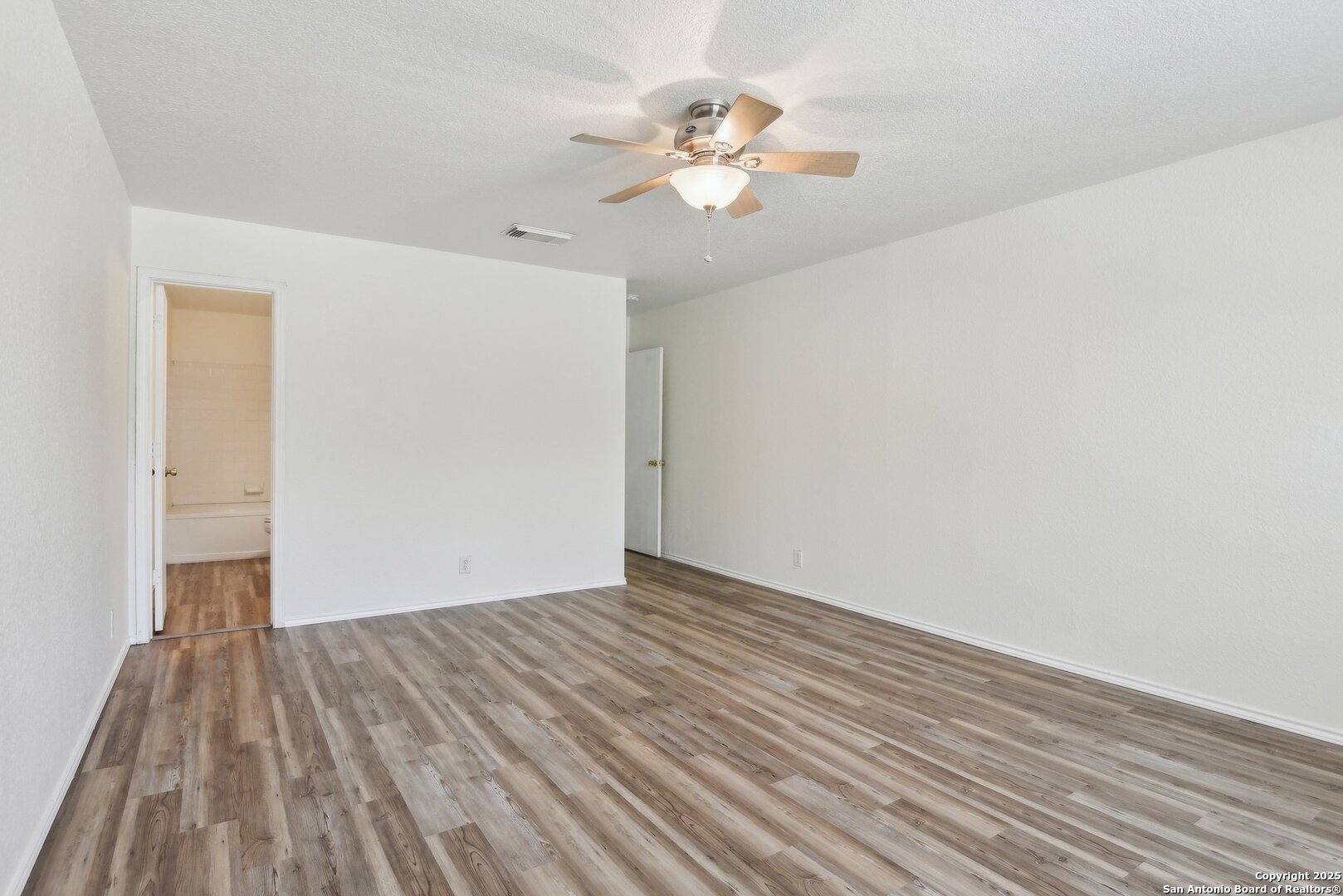 16216 Ike Lane Selma, TX 78154 - Photo 22 of 40 a view of a room with wooden floor and a ceiling fan