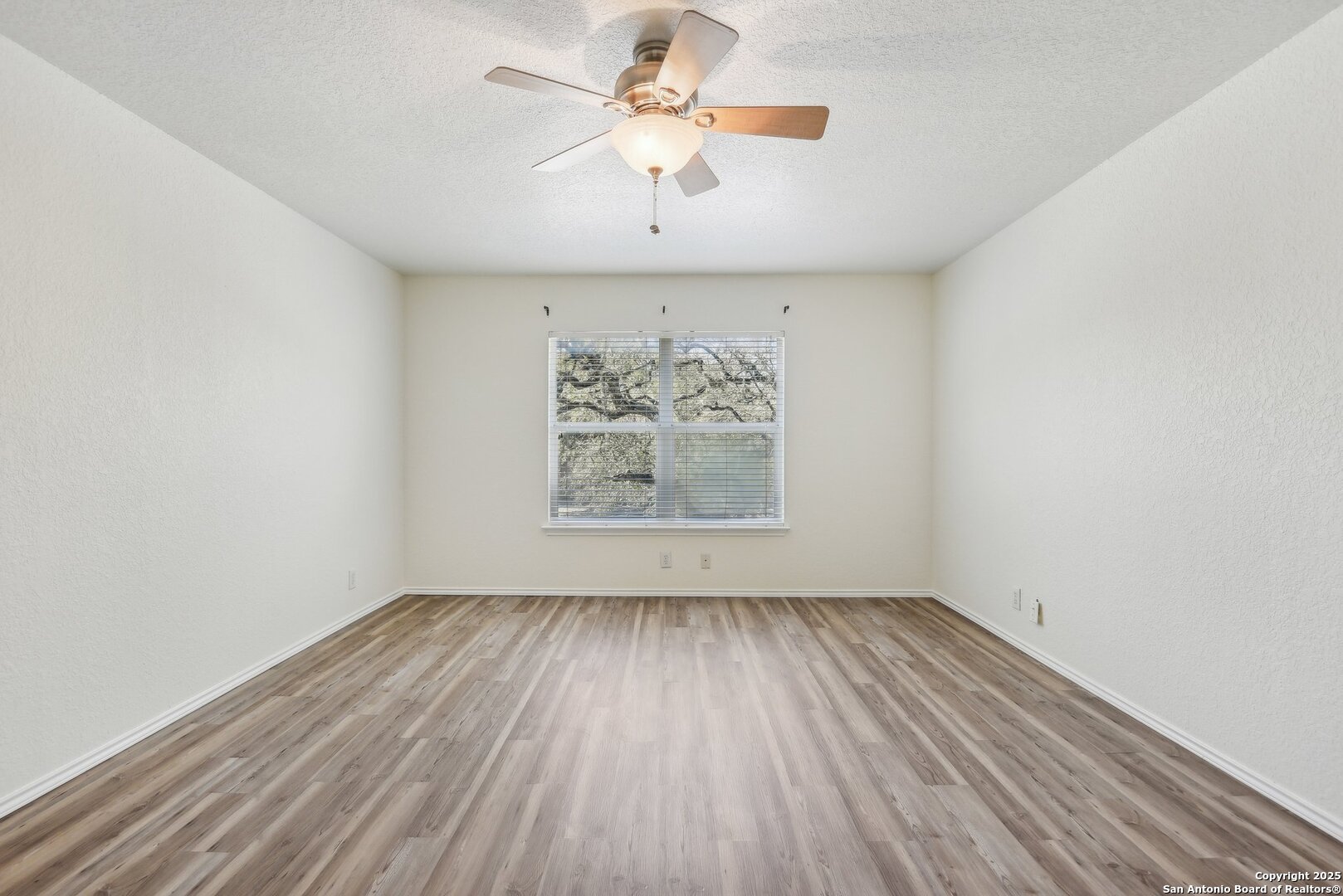 16216 Ike Lane Selma, TX 78154 - Photo 24 of 40 an empty room with a window and a fan