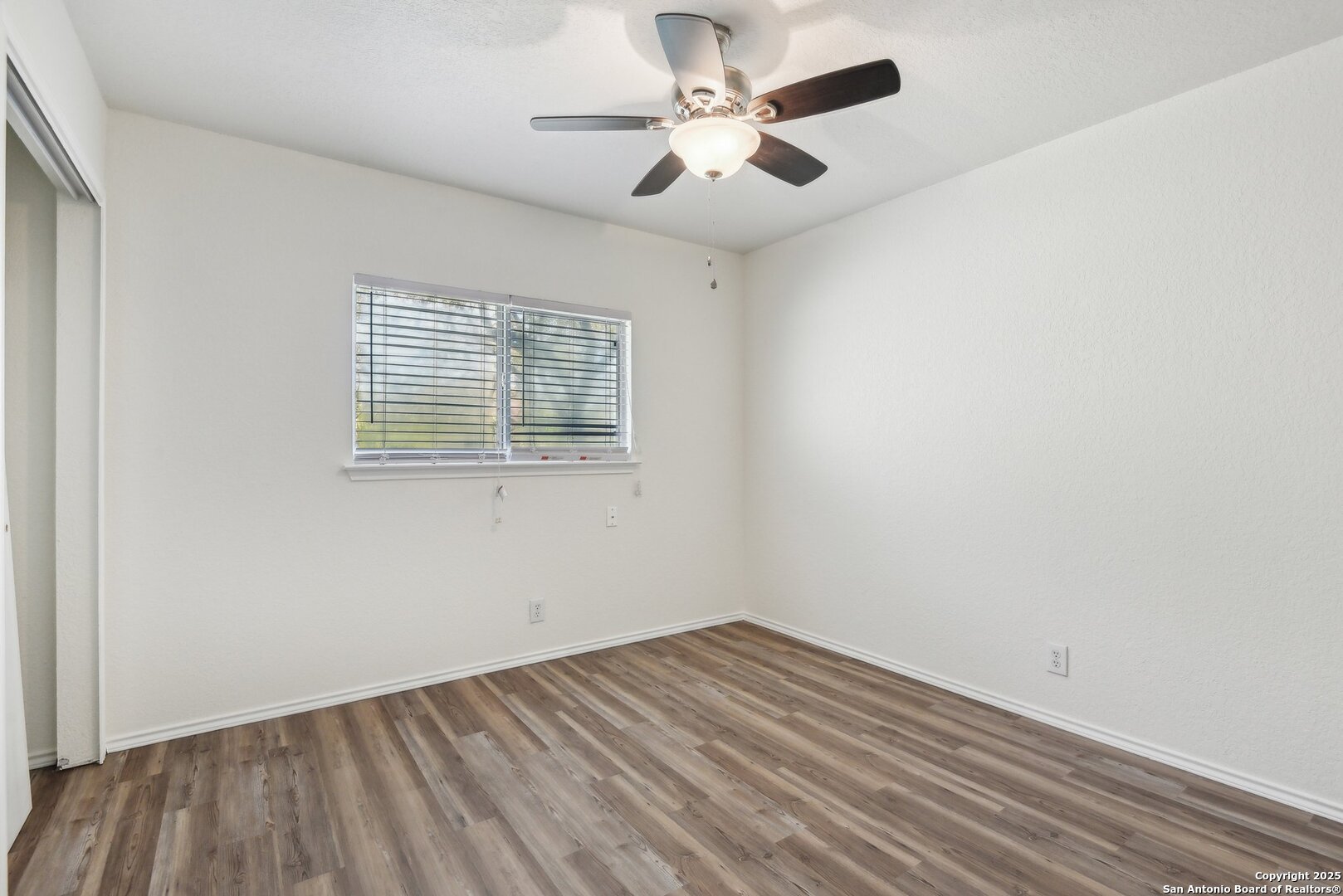 16216 Ike Lane Selma, TX 78154 - Photo 26 of 40 an empty room with a window and a ceiling fan