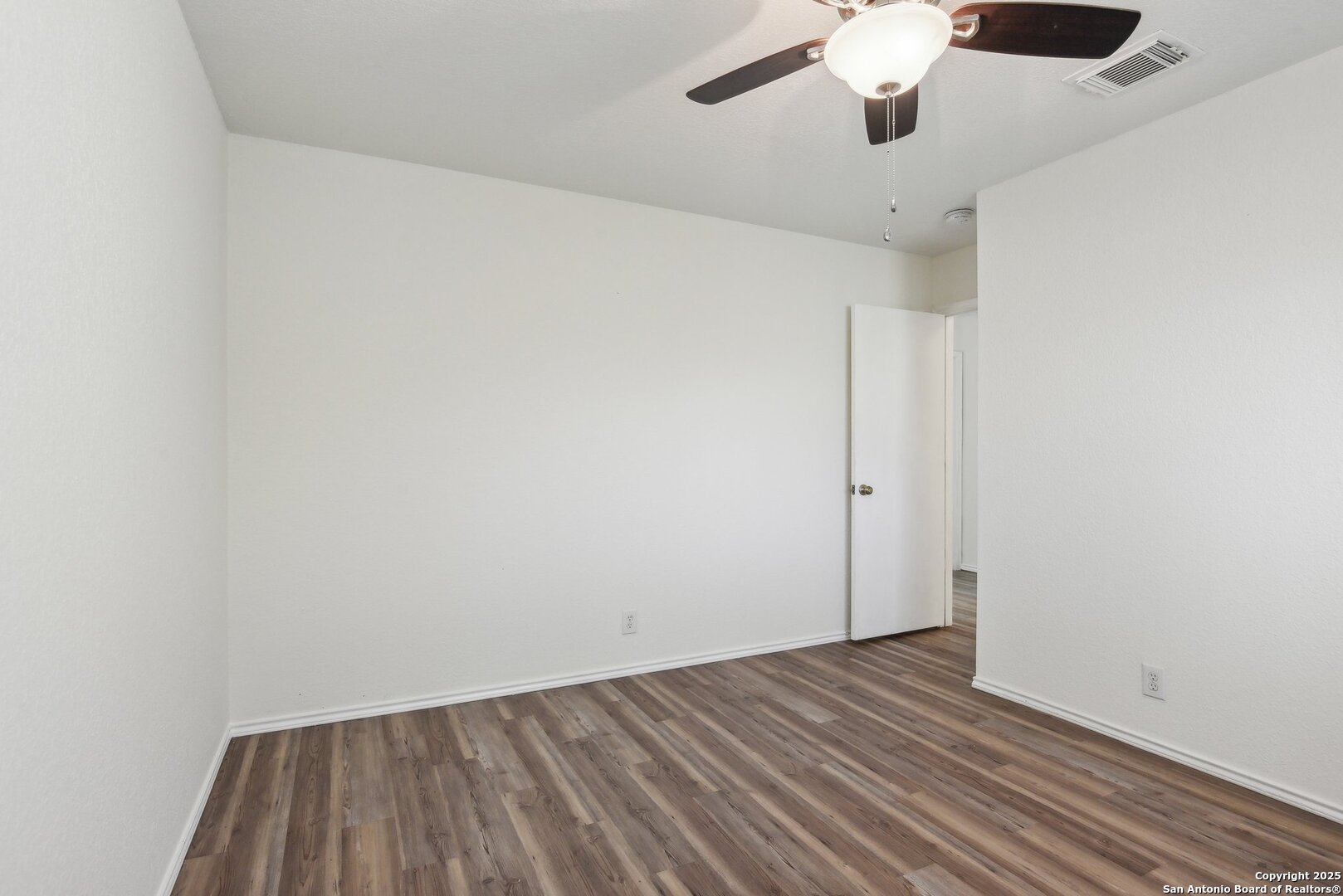 16216 Ike Lane Selma, TX 78154 - Photo 28 of 40 an empty room with wooden floor chandelier fan and closet
