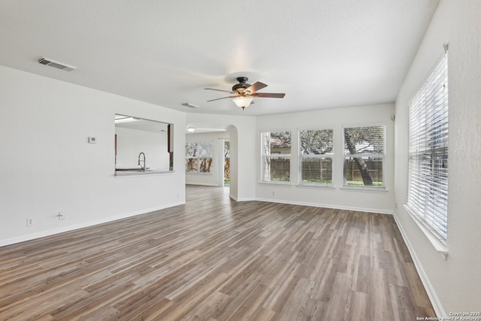 16216 Ike Lane Selma, TX 78154 - Photo 3 of 40 a view of an empty room with wooden floor and a window