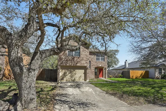 a front view of a house with a yard and a garage