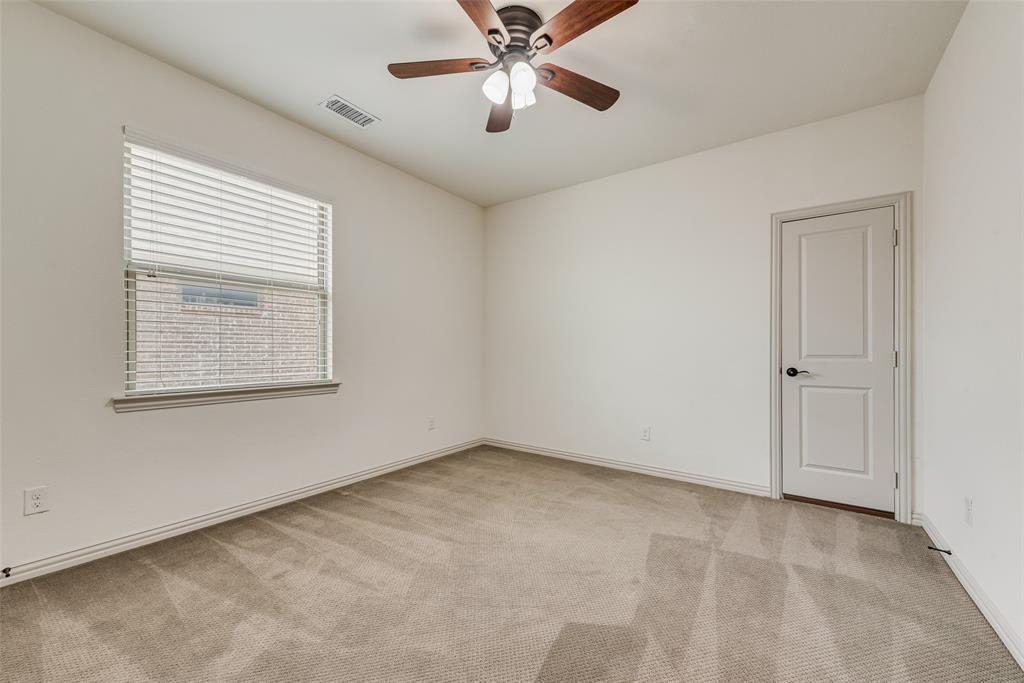 2021 Calisto Way Allen, TX 75013 - Photo 27 of 34 Spacious room featuring neutral carpet flooring, a ceiling fan with light fixture, a window with horizontal blinds, and a paneled door with dark hardware