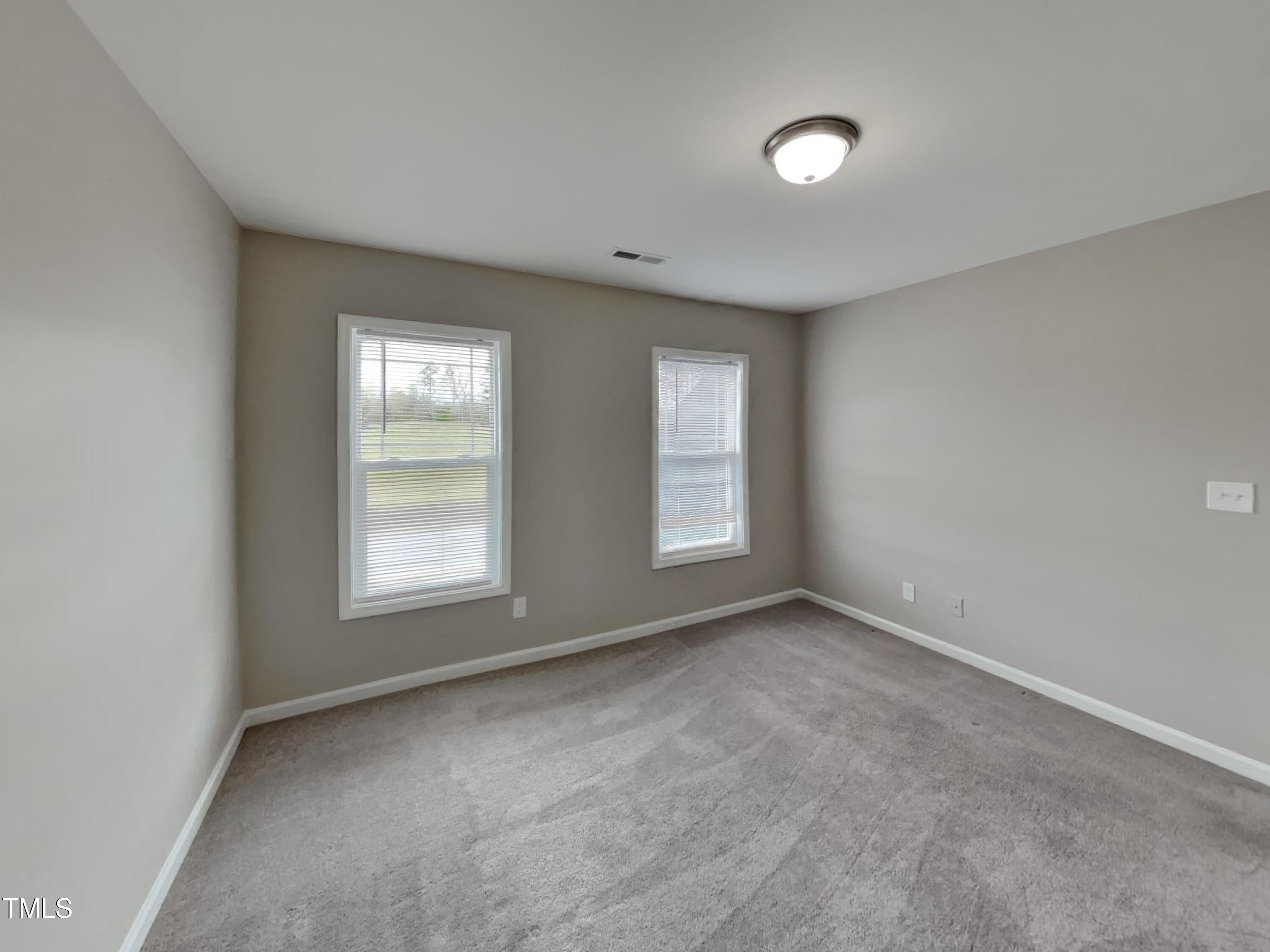 67 Weathervane Dr. Zebulon, NC 27597 - Photo 11 of 17 an empty room with windows and closet