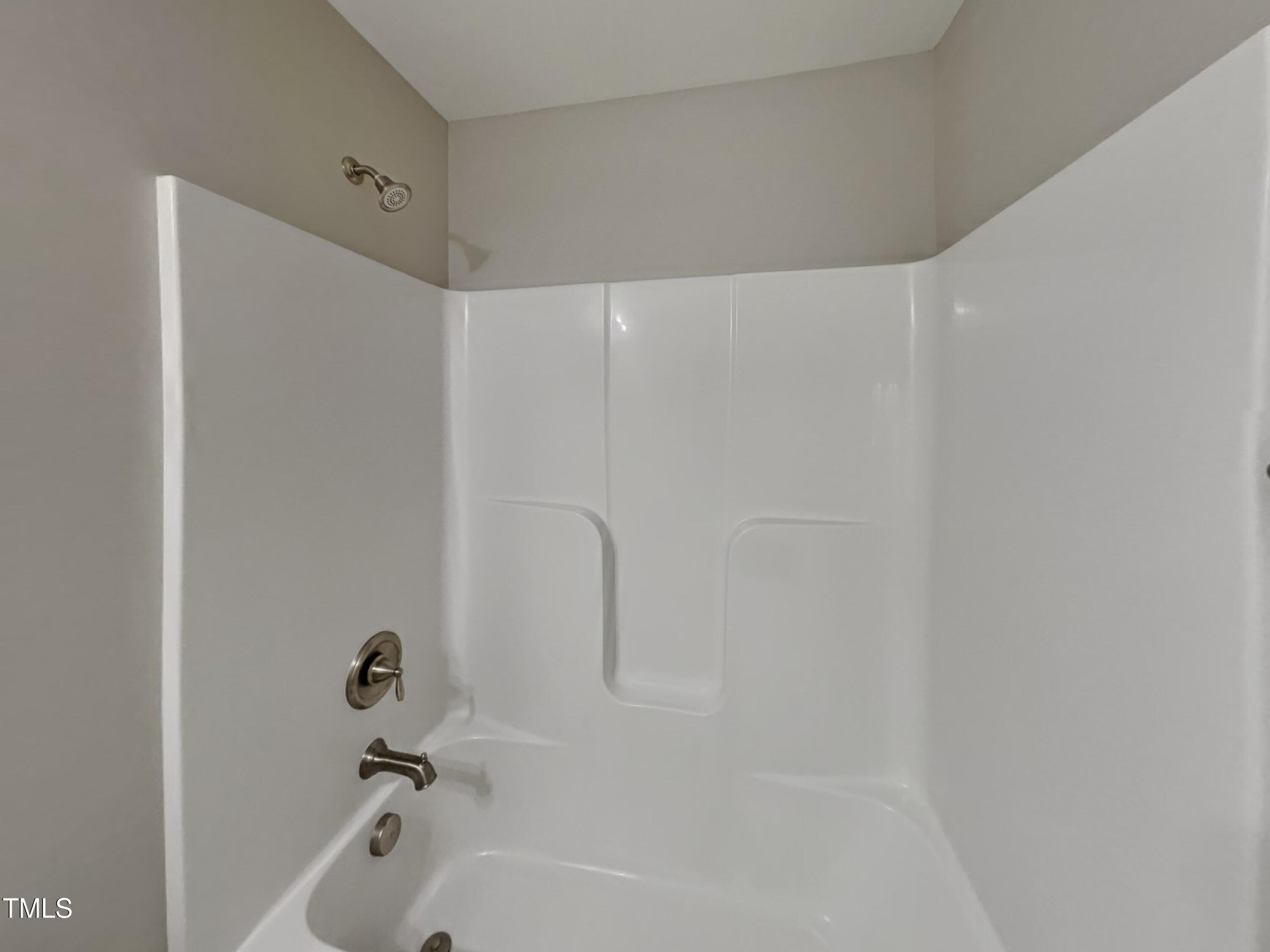67 Weathervane Dr. Zebulon, NC 27597 - Photo 15 of 17 a bathroom with a bathtub