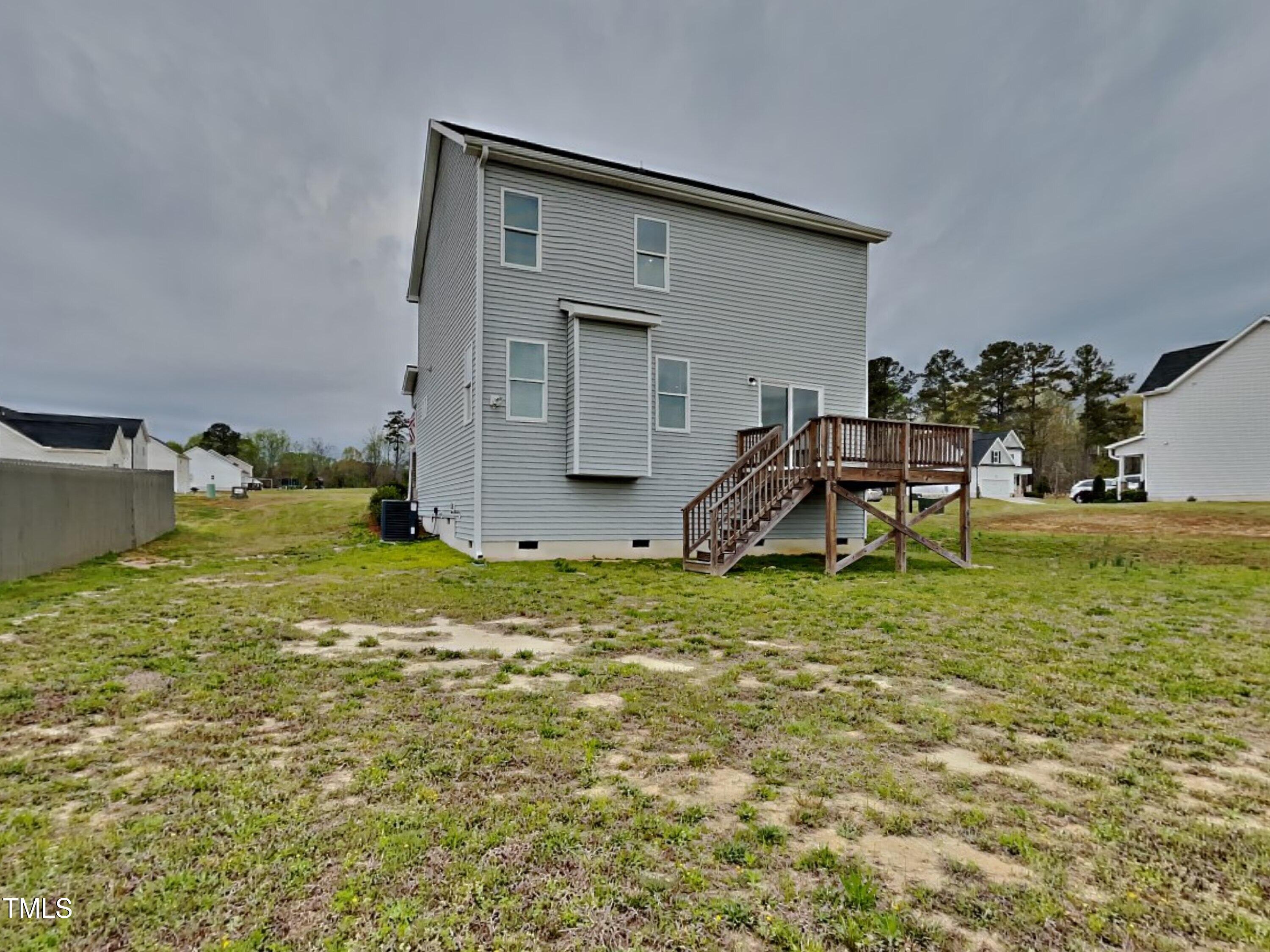 67 Weathervane Dr. Zebulon, NC 27597 - Photo 17 of 17 a backyard of a house with table and chairs