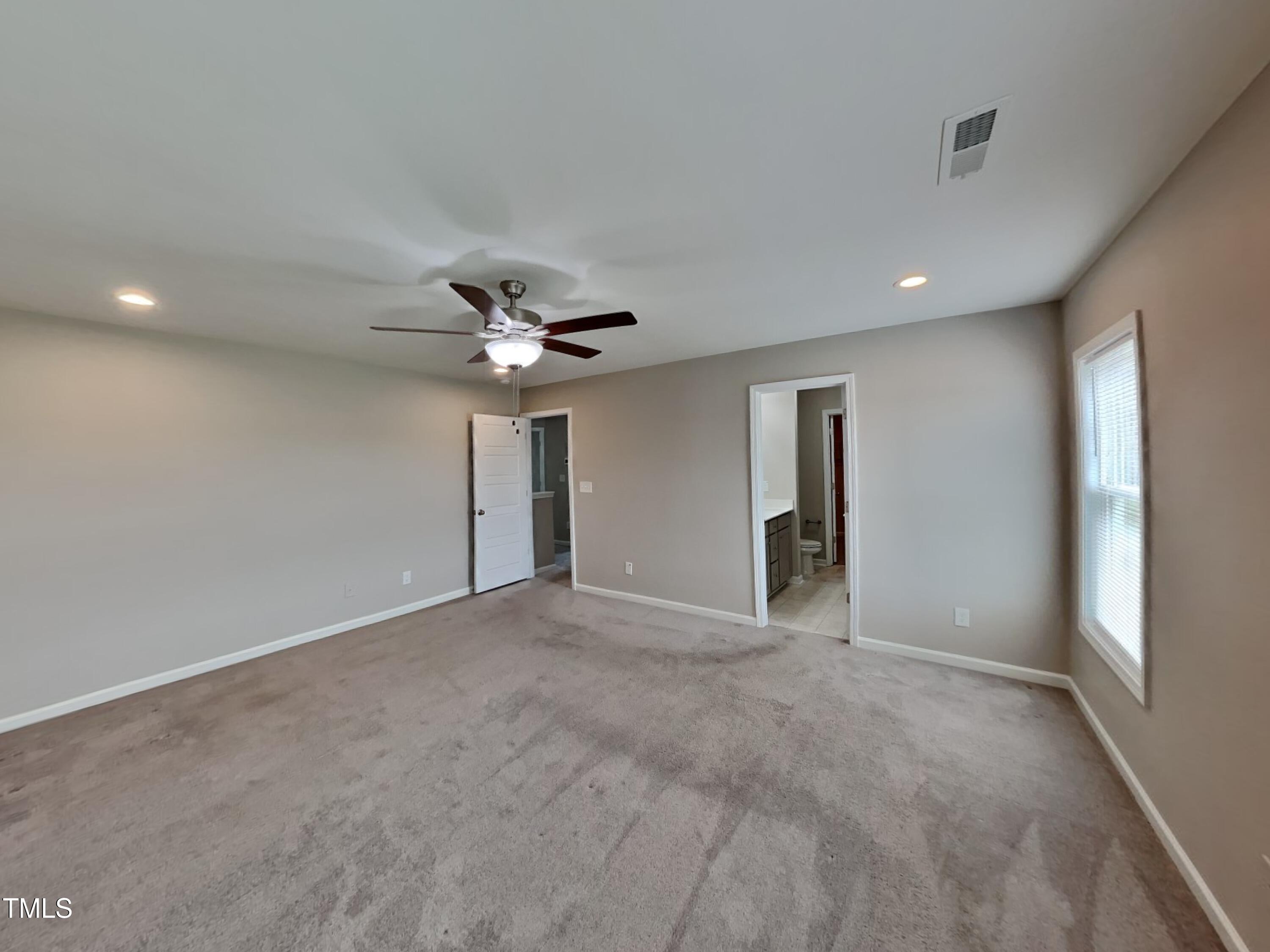 67 Weathervane Dr. Zebulon, NC 27597 - Photo 8 of 17 a view of an empty room with a ceiling fan