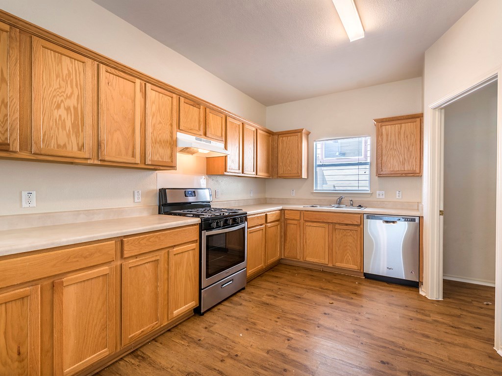 501 Sampson Kyle, TX 78640 - Photo 1 of 1 a kitchen with stainless steel appliances granite countertop a stove a sink and white cabinets
