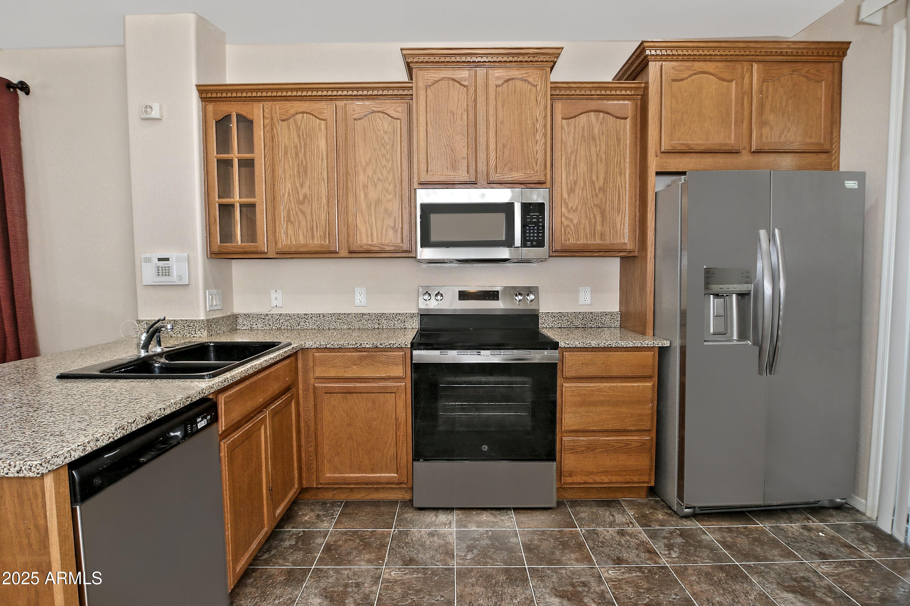 2785 South Alpine Drive Gilbert, AZ 85295 - Photo 13 of 31 a kitchen with stainless steel appliances granite countertop a stove a sink and a refrigerator