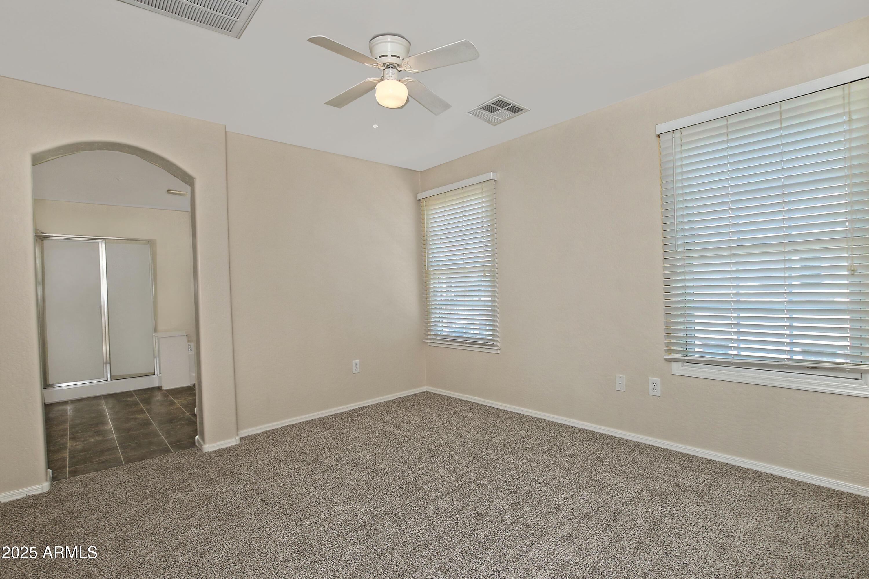 2785 South Alpine Drive Gilbert, AZ 85295 - Photo 18 of 31 an empty room with windows and fan