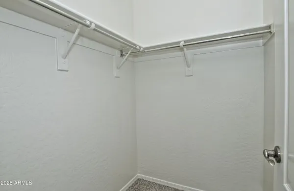 a spacious bathroom with a double vanity sink a mirror and a bathtub