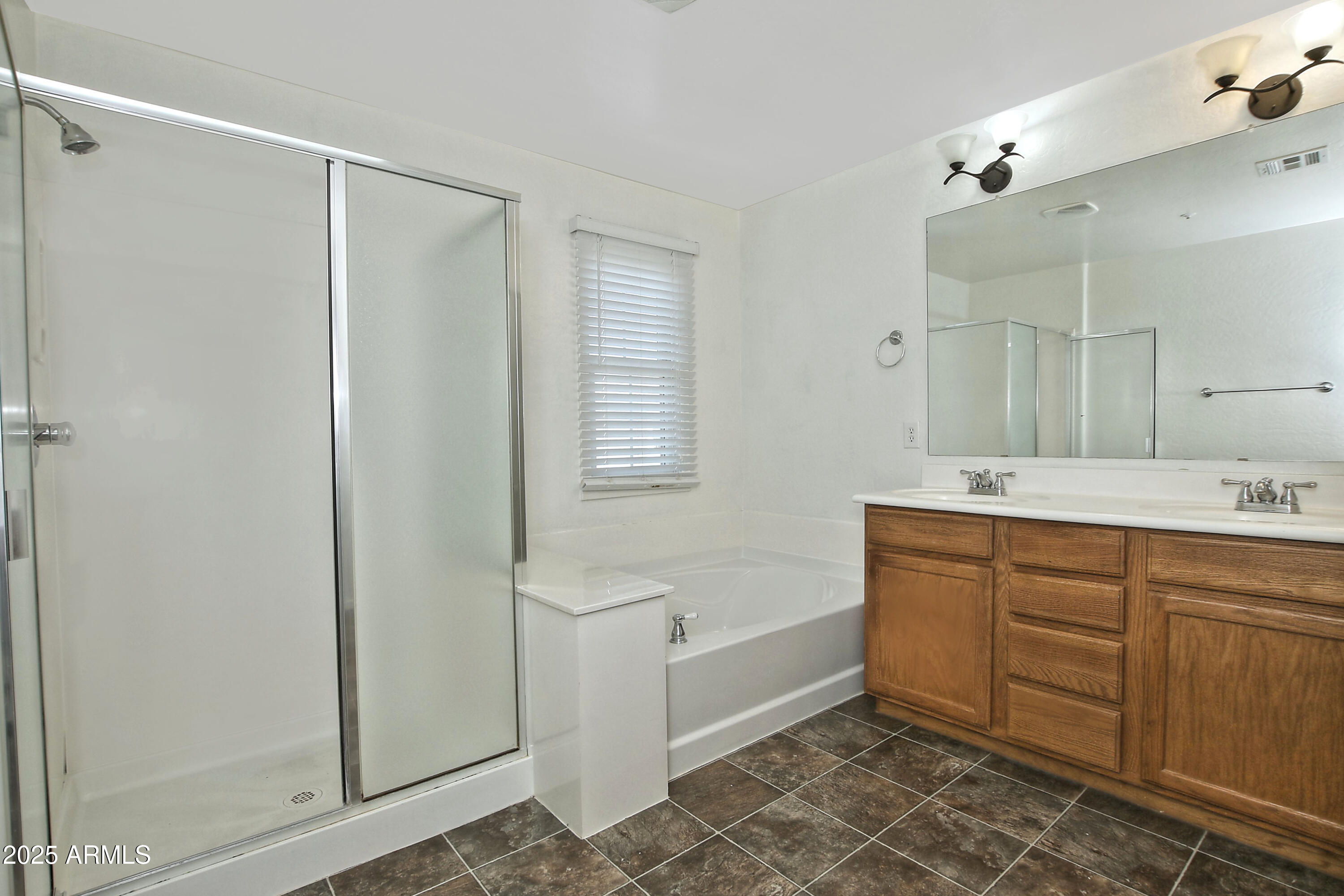 2785 South Alpine Drive Gilbert, AZ 85295 - Photo 21 of 31 a spacious bathroom with a double vanity sink a mirror and a bathtub