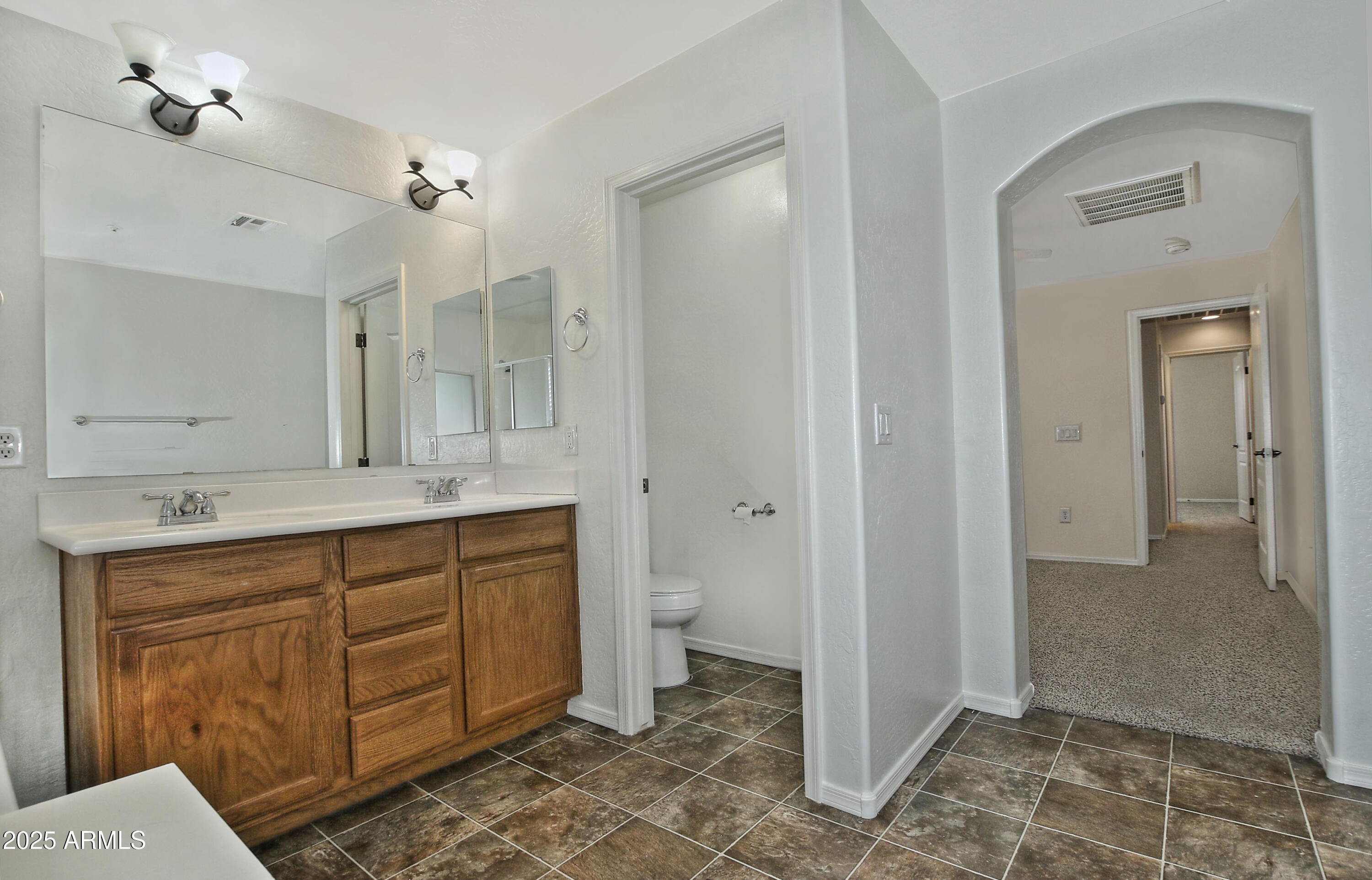 2785 South Alpine Drive Gilbert, AZ 85295 - Photo 22 of 31 a spacious bathroom with a granite countertop sink mirror and a toilet