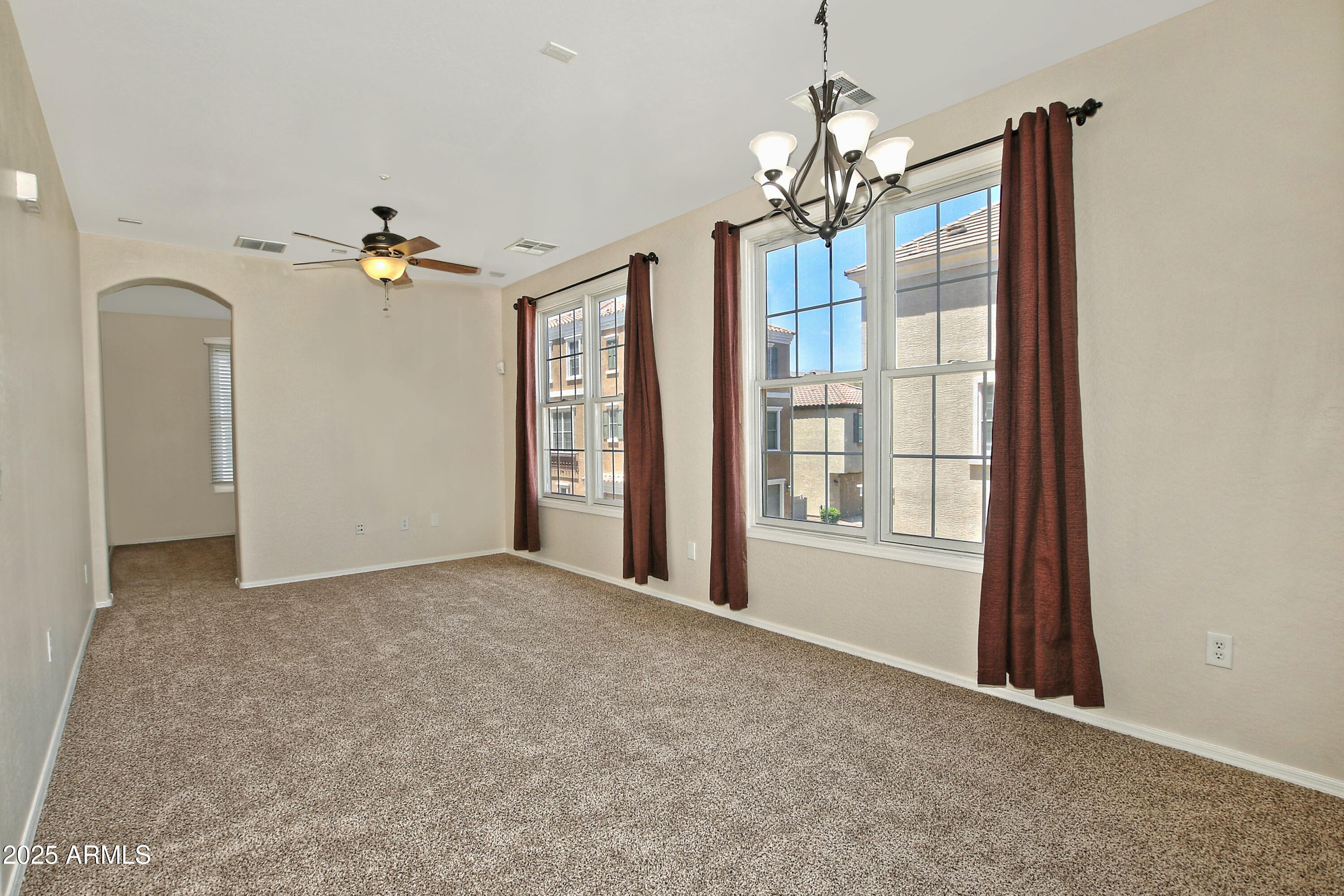 2785 South Alpine Drive Gilbert, AZ 85295 - Photo 9 of 31 a view of a livingroom with a chandelier fan and windows
