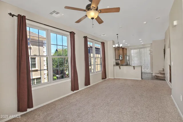 a view of a kitchen with a refrigerator and a chandelier fan