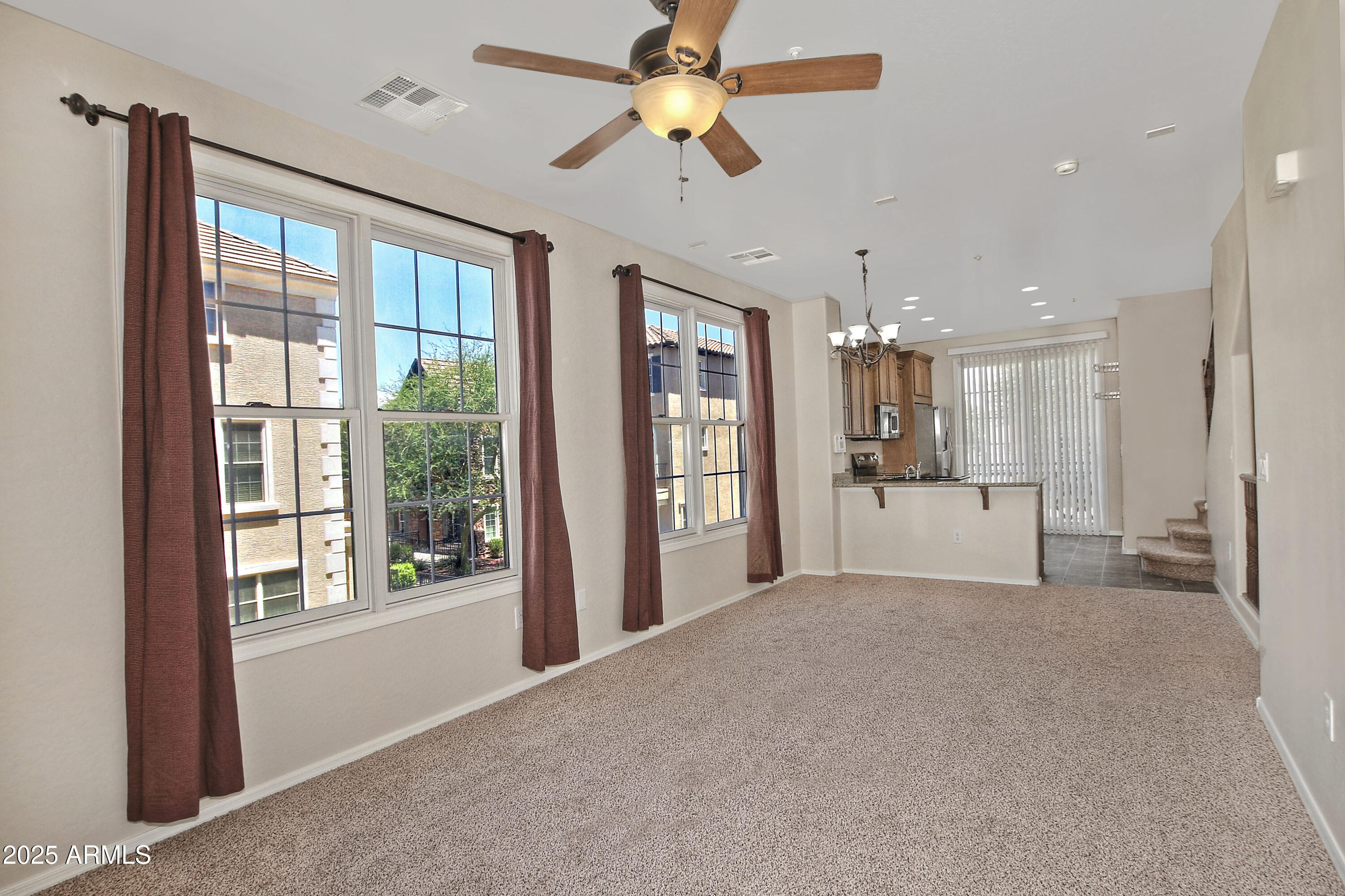 2785 South Alpine Drive Gilbert, AZ 85295 - Photo 10 of 31 a view of a kitchen with a refrigerator and a chandelier fan