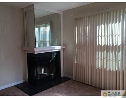 101 Raintree Court Helmetta, NJ 08828 - Photo 8 of 9 a view of an empty room with wooden floor and a window