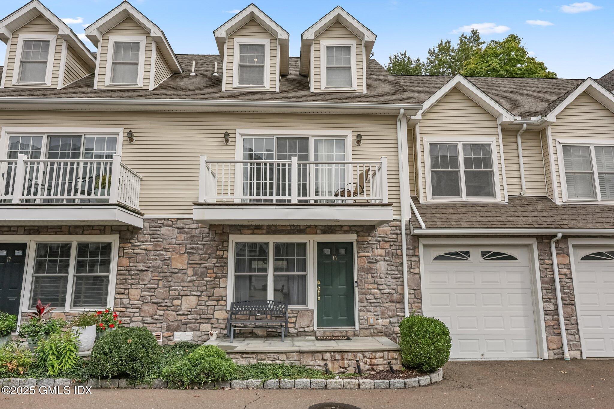 39 Maple Tree Avenue, Unit 16 Stamford, CT 06906 - Photo 1 of 21 a front view of a house with a yard and garage