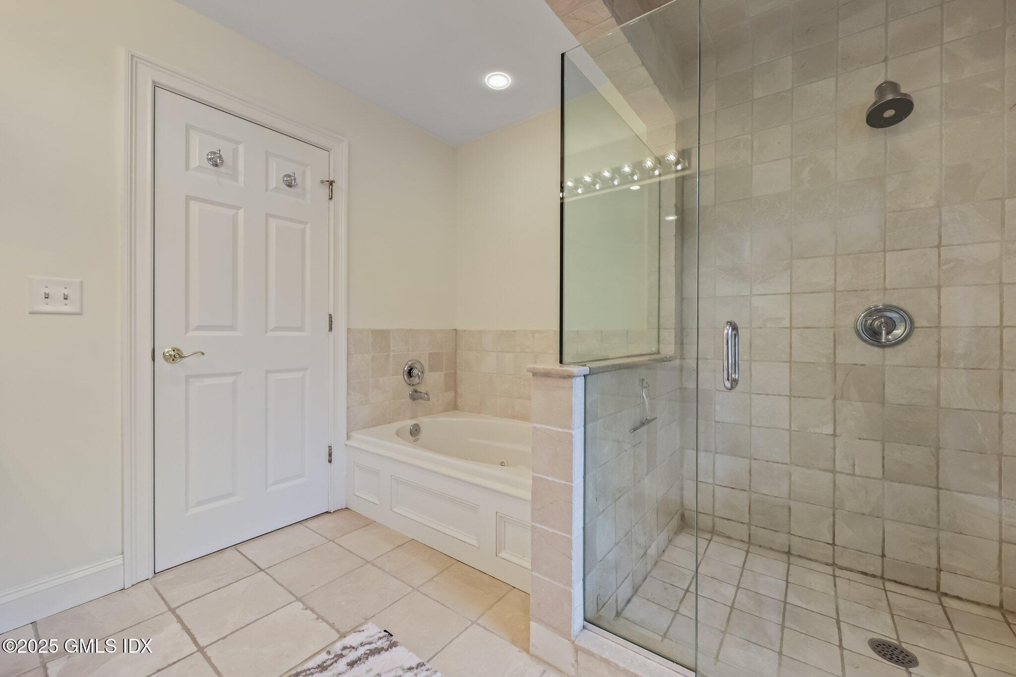 39 Maple Tree Avenue, Unit 16 Stamford, CT 06906 - Photo 11 of 21 a bathroom with a bathtub and a shower