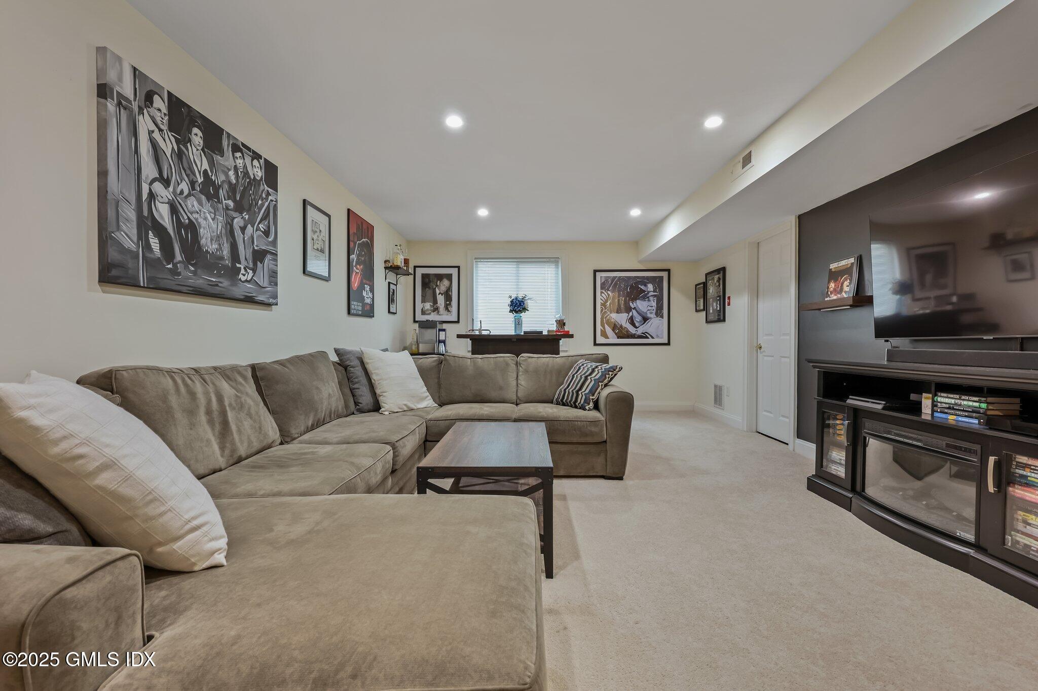 39 Maple Tree Avenue, Unit 16 Stamford, CT 06906 - Photo 16 of 21 a living room with furniture and a flat screen tv