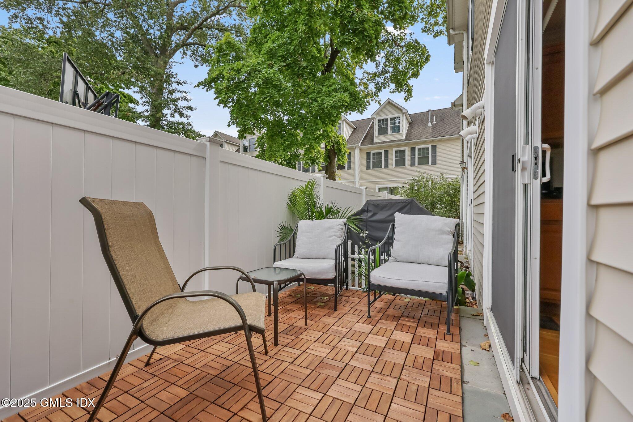 39 Maple Tree Avenue, Unit 16 Stamford, CT 06906 - Photo 20 of 21 a view of a chair and table in the balcony