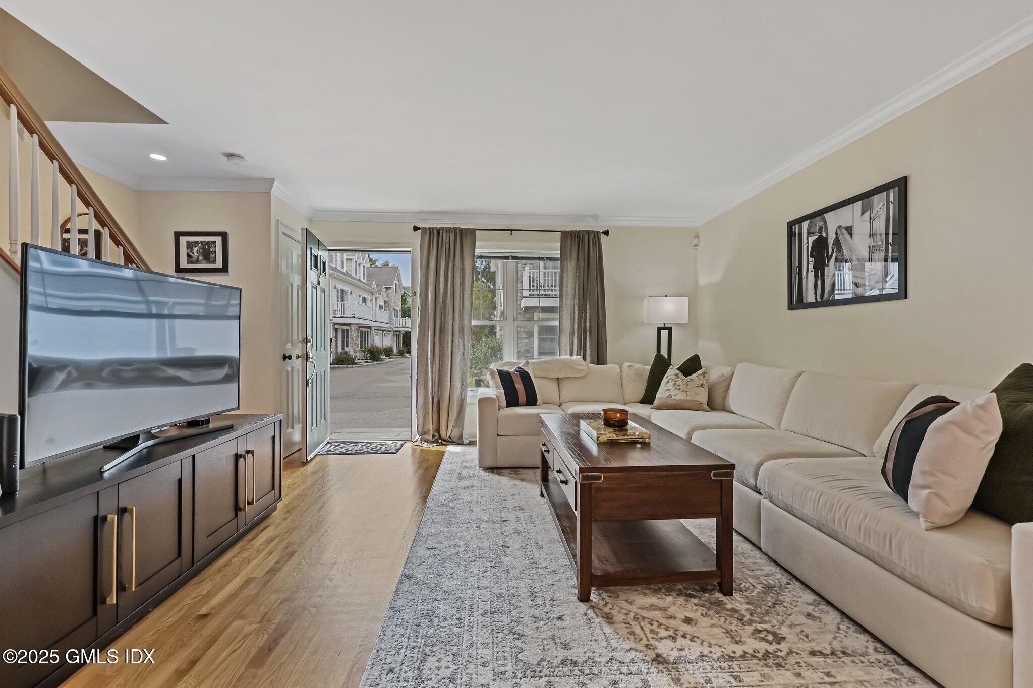 39 Maple Tree Avenue, Unit 16 Stamford, CT 06906 - Photo 2 of 21 a living room with furniture and a flat screen tv