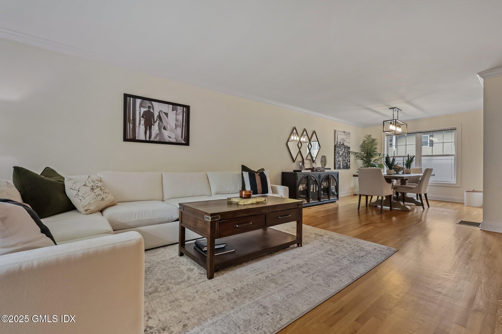 39 Maple Tree Avenue, Unit 16 Stamford, CT 06906 - Photo 4 of 21 a living room with furniture and wooden floor