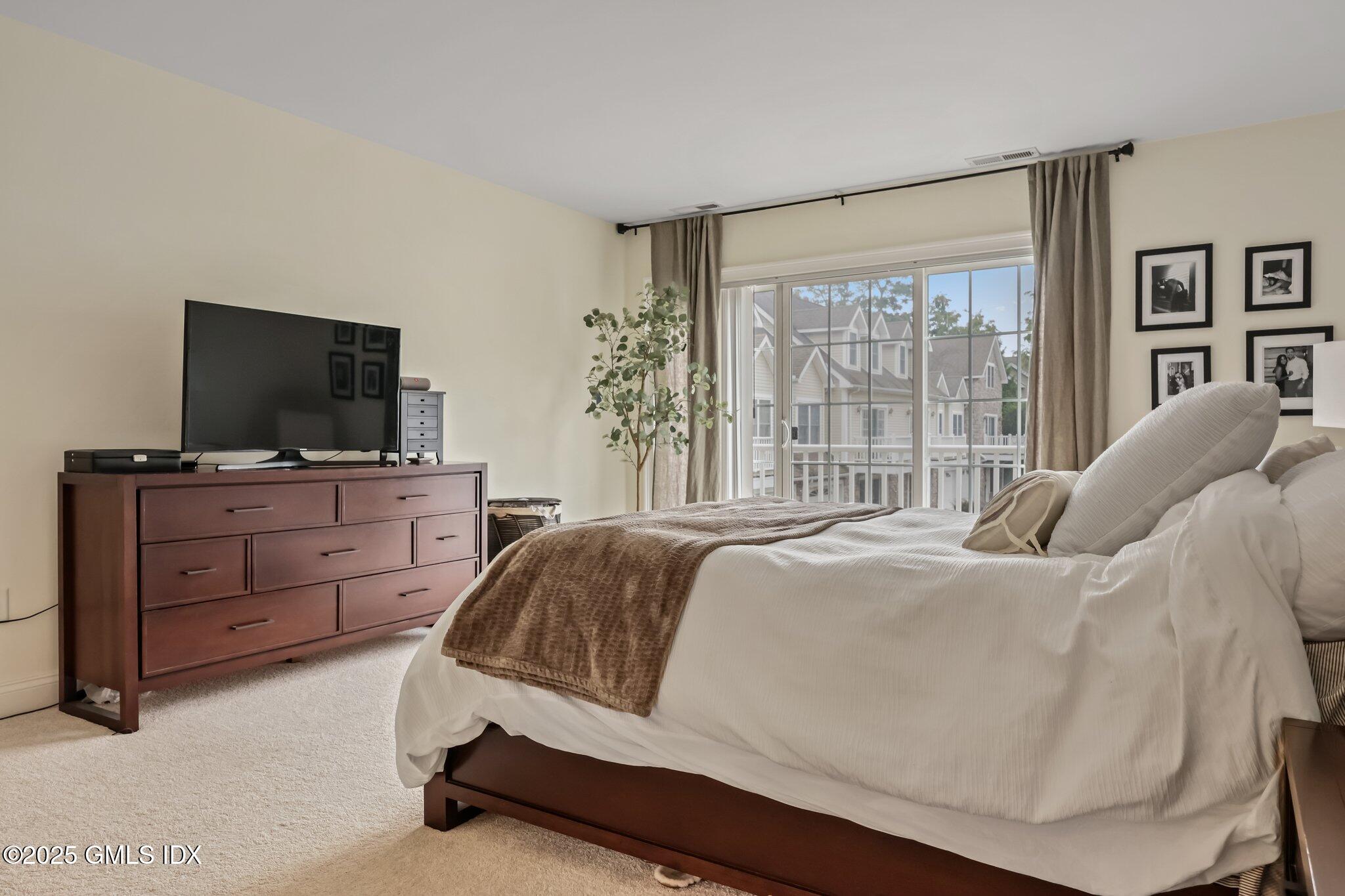 39 Maple Tree Avenue, Unit 16 Stamford, CT 06906 - Photo 9 of 21 a living room with furniture and a flat screen tv