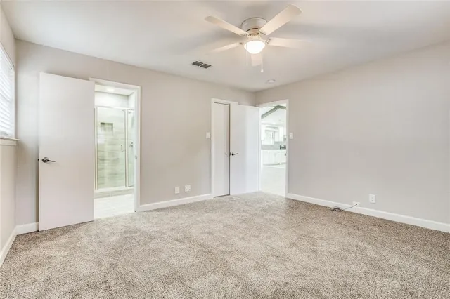 an empty room with an entryway and closet area
