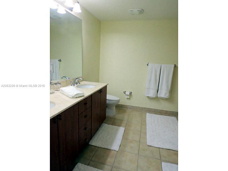 888 Douglas Road, Unit 1016 Coral Gables, FL 33134 - Photo 11 of 34 a bathroom with a sink and a mirror