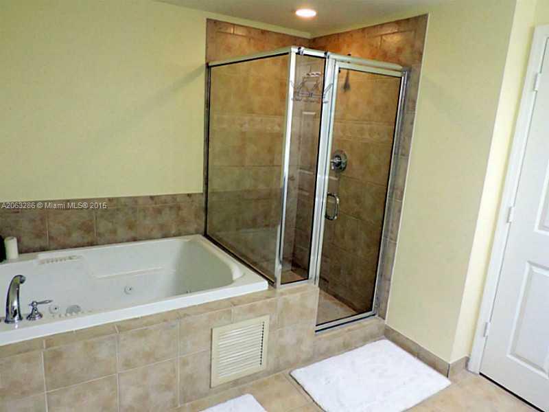 888 Douglas Road, Unit 1016 Coral Gables, FL 33134 - Photo 12 of 34 a bathroom with a bathtub and a shower