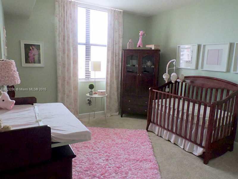 888 Douglas Road, Unit 1016 Coral Gables, FL 33134 - Photo 16 of 34 a bed room with a bed and a window