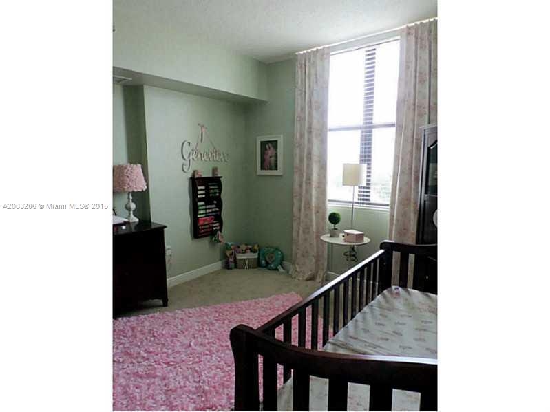 888 Douglas Road, Unit 1016 Coral Gables, FL 33134 - Photo 17 of 34 a view of a hallway with wooden floor and staircase