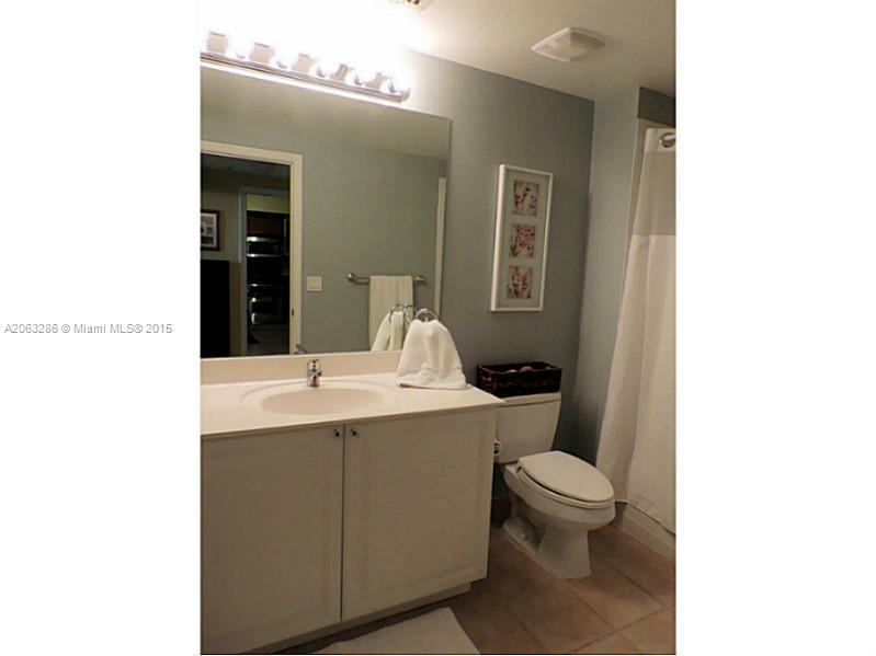 888 Douglas Road, Unit 1016 Coral Gables, FL 33134 - Photo 20 of 34 a bathroom with a toilet a sink and mirror