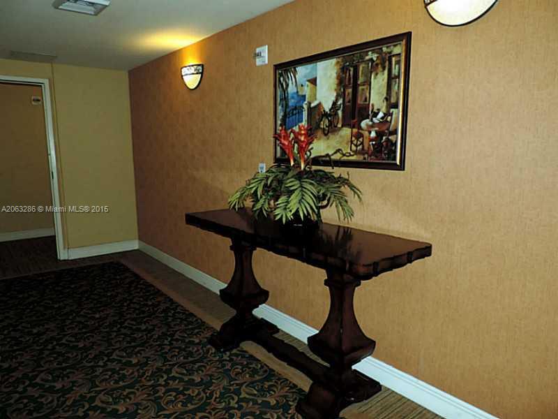 888 Douglas Road, Unit 1016 Coral Gables, FL 33134 - Photo 21 of 34 a room with painting on the wall and a potted plant