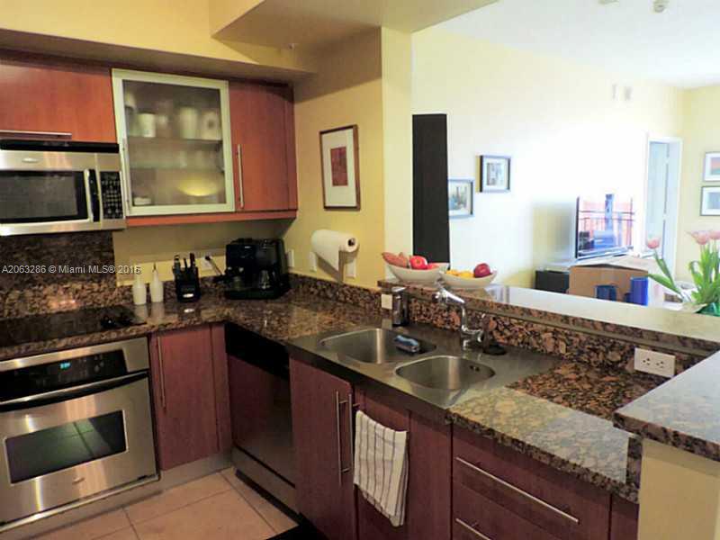 888 Douglas Road, Unit 1016 Coral Gables, FL 33134 - Photo 3 of 34 a kitchen with granite countertop a sink and stainless steel appliances