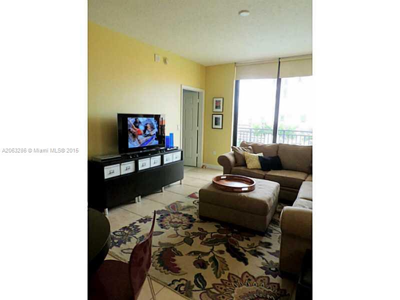 888 Douglas Road, Unit 1016 Coral Gables, FL 33134 - Photo 5 of 34 a living room with furniture and a flat screen tv