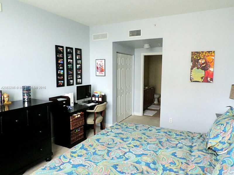 888 Douglas Road, Unit 1016 Coral Gables, FL 33134 - Photo 9 of 34 a bedroom with a bed and furniture