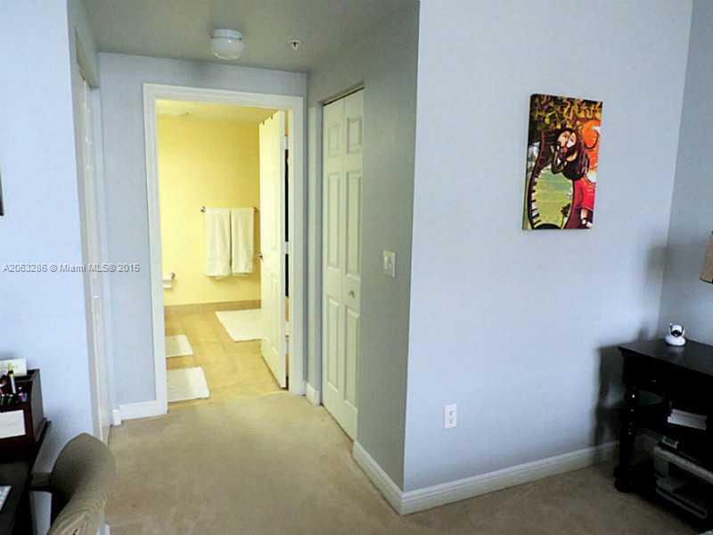 888 Douglas Road, Unit 1016 Coral Gables, FL 33134 - Photo 10 of 34 a view of a bedroom with a bed and toys