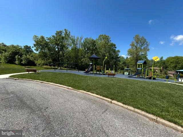 a view of a park and trees in the background