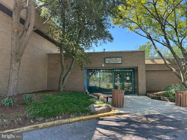 a view of a chair and table in backyard of the house