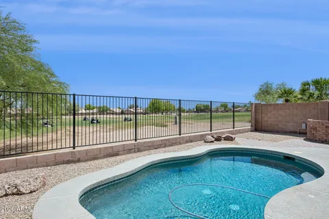 a view of a backyard with a swimming pool