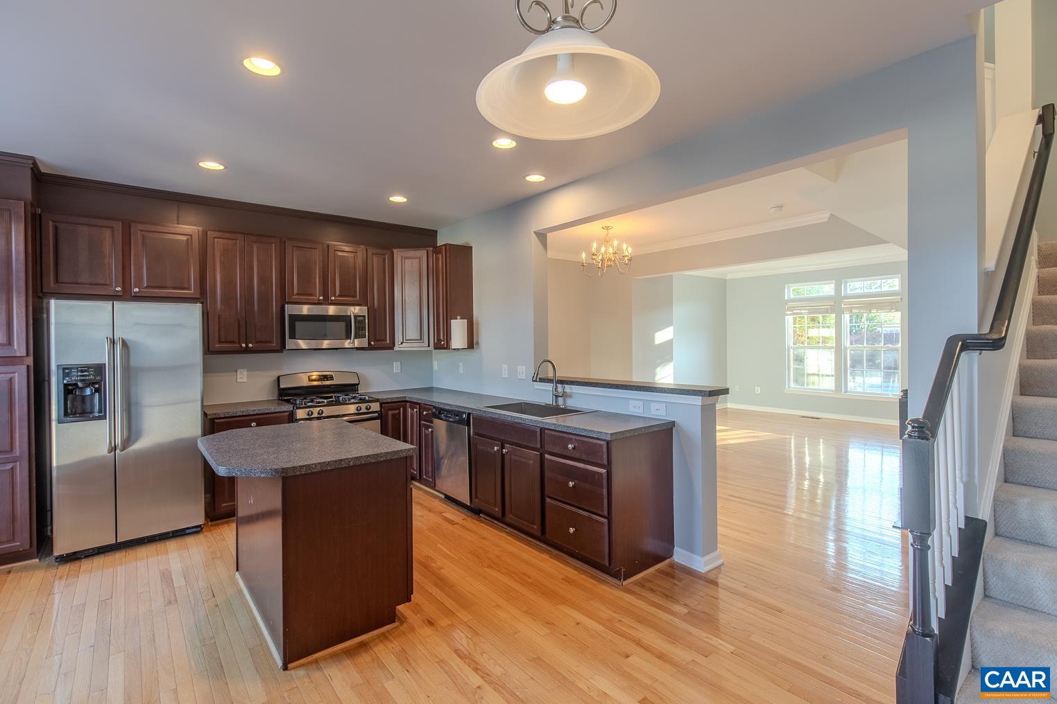 339 Rolkin Road Charlottesville, VA 22911 - Photo 17 of 43 a large kitchen with stainless steel appliances wooden floors and wooden cabinets